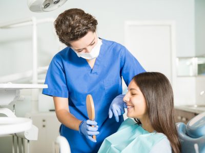 dentist showing a teenager her smile