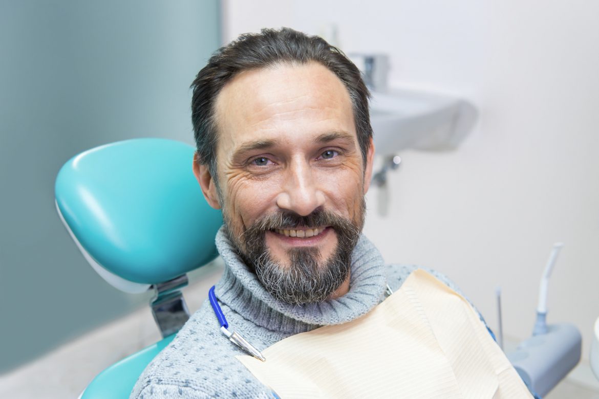man in turtleneck in dental chair